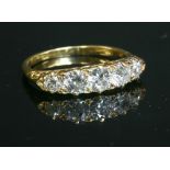 An Edwardian five stone diamond carved head ring