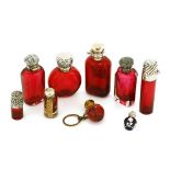 Eight silver and cranberry glass scent bottles,