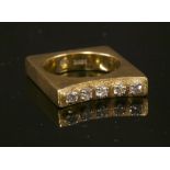A gold five stone diamond set square shaped ring