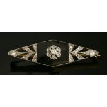An Art Deco diamond and onyx lozenge-shaped brooch