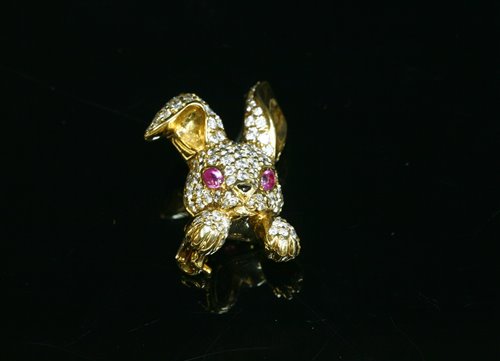 An 18ct gold ruby and diamond novelty rabbit brooch, by David Morris,