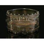 A late Victorian silver flat section hinged bangle,