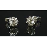 A pair of white gold, single stone diamond stud earrings