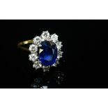 An 18ct gold sapphire and diamond oval cluster ring