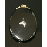 A Victorian gold oval onyx glazed pendant/brooch picture locket