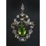 A Victorian peridot and diamond cartouche shaped pendant/brooch, c.1890,