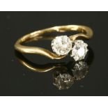 A two stone diamond crossover ring