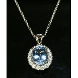 A platinum aquamarine and diamond cluster pendant,