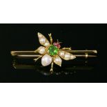 An Edwardian gold, green paste, ruby and split pearl set insect bar brooch, c.1905,