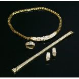 An 18ct gold diamond set jarretière necklace, bracelet, earring and ring suite