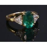 A French three stone emerald and diamond gold ring