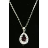 An 18ct white gold ruby and diamond cluster pendant,