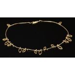 A gold diamond and pierced leaf link necklace, by Louise O'Neill,