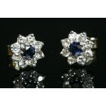 A pair of gold sapphire and diamond circular cluster earrings