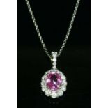 A platinum pink sapphire and diamond cluster pendant,