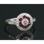 A platinum, diamond and ruby target style cluster ring,