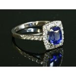 An 18ct white gold sapphire and diamond cluster ring