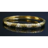 An 18ct gold diamond set bangle,