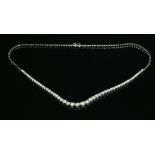 A white gold diamond set graduated riviere necklace,