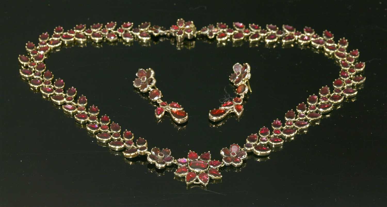 A Georgian cased gold flat cut foiled garnet necklace and earring suite,