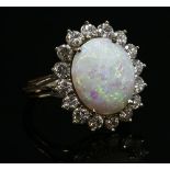 A white gold opal and diamond oval cluster ring,
