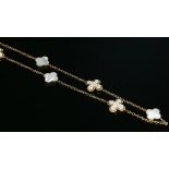 A rose gold mother of pearl and diamond long chain,
