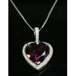 A platinum garnet and diamond heart shaped pendant,