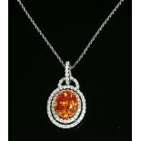 An 18ct white gold spessartine garnet and diamond two row halo cluster pendant