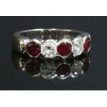 A platinum five stone ruby and diamond half eternity ring