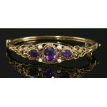 A Victorian style amethyst and split pearl hinged bangle,