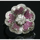 A white gold diamond and ruby flower head cocktail ring,