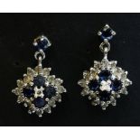 A pair of 18ct white gold diamond and sapphire cluster drop earrings