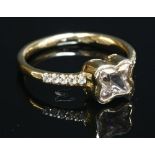 An 18ct rose gold single stone sapphire ring with diamond set shoulders