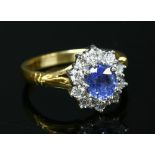 An 18ct gold sapphire and diamond oval cluster ring,