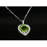 An Edwardian peridot and diamond heart shaped pendant