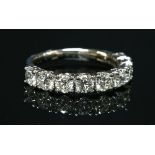 A platinum diamond set half hoop ring,