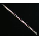 An Art Deco ruby and diamond line bracelet,