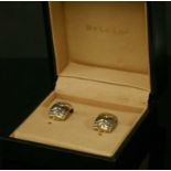 A pair of gold diamond set 'C' shaped earrings