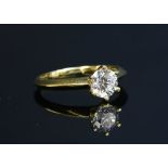 A gold single stone diamond ring