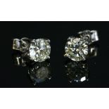 A pair of 18ct white gold single stone diamond stud earrings,