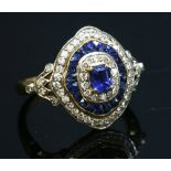 A two colour gold sapphire and diamond target style cluster ring