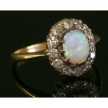 A gold opal and diamond cluster ring