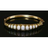 An Edwardian 9ct gold hinged opal bangle, c.1900,