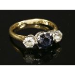 A three stone sapphire and diamond ring