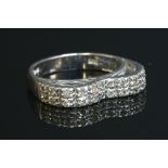 An 18ct white gold diamond set half hoop ring