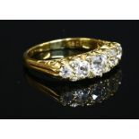 A five stone graduated diamond carved head style ring,