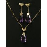 An amethyst and diamond matching gold pendant and earring suite