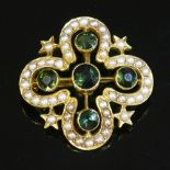 A late Victorian gold, green tourmaline and split pearl quatrefoil brooch/pendant,