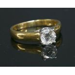 A gold single stone diamond ring