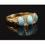 An 18ct gold turquoise and diamond carved head ring, c.1900,